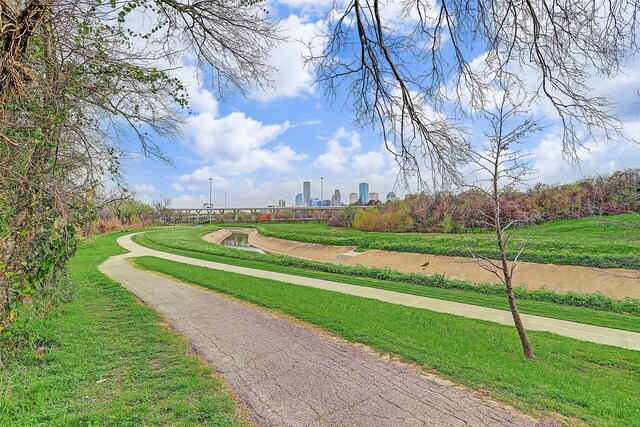 view of home's community with a city view and a lawn