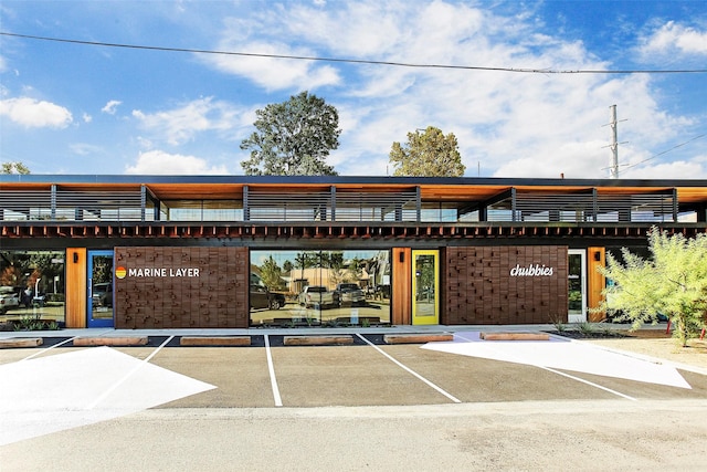 view of building exterior with uncovered parking