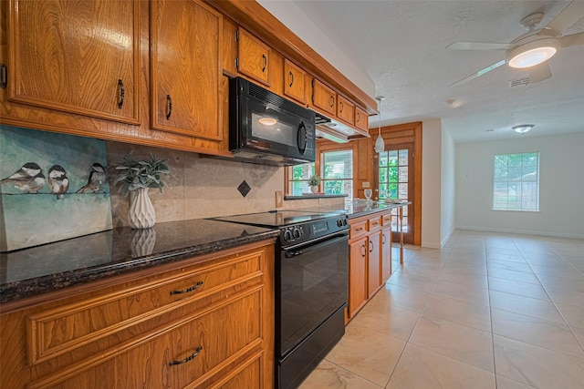 26003 Fountaine Bleau Dr, Tomball, TX 77377 - kitchen featuring black appliances, brown cabinetry, backsplash, baseboards, and a ceiling fan
