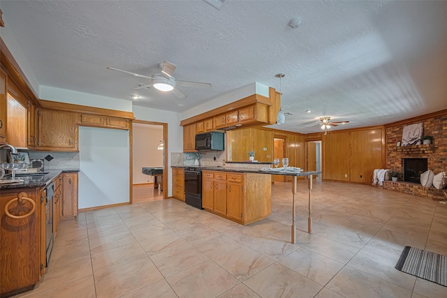 26003 Fountaine Bleau Dr, Tomball, TX 77377 - kitchen featuring a ceiling fan, black appliances, a peninsula, dark countertops, and brown cabinets