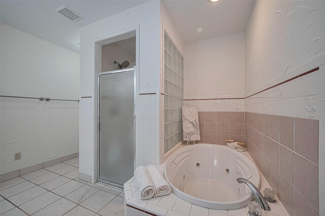 26003 Fountaine Bleau Dr, Tomball, TX 77377 - full bathroom featuring a stall shower, a jetted tub, and tile patterned flooring