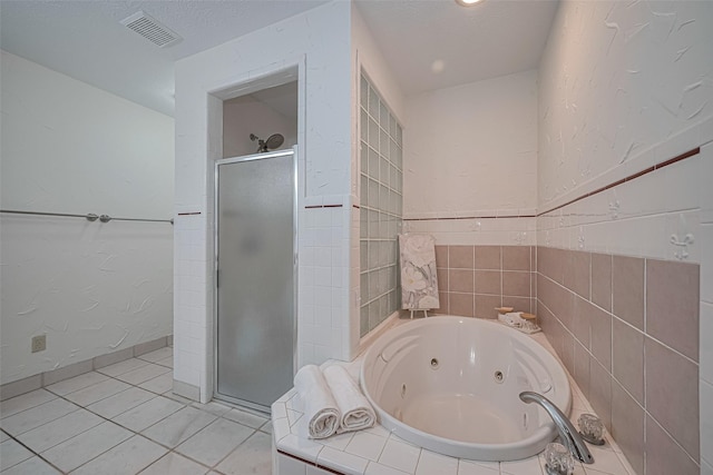 26003 Fountaine Bleau Dr, Tomball, TX 77377 - full bathroom featuring a stall shower, a jetted tub, and tile patterned flooring
