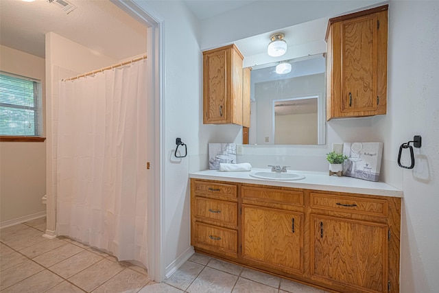 26003 Fountaine Bleau Dr, Tomball, TX 77377 - full bath featuring tile patterned flooring, vanity, baseboards, and a shower with curtain