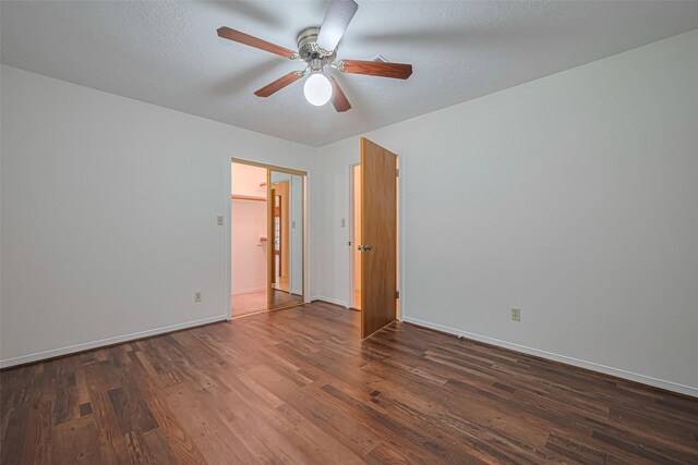 26003 Fountaine Bleau Dr, Tomball, TX 77377 - unfurnished bedroom with wood-type flooring, baseboards, and ceiling fan