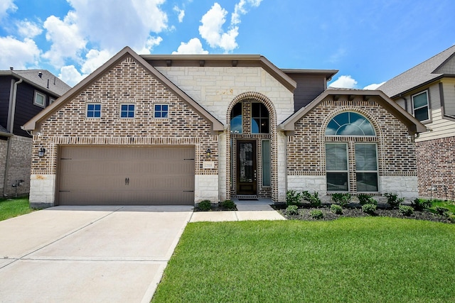 french country style house featuring stone siding, an attached garage, a front lawn, and concrete driveway