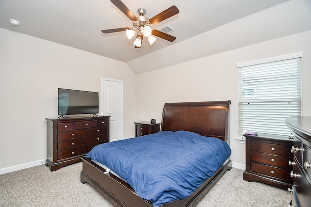 bedroom with lofted ceiling, light carpet, baseboards, and visible vents