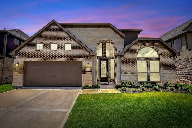 view of front of home featuring concrete driveway, an attached garage, stone siding, and a front lawn