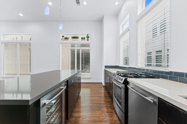kitchen with visible vents, dishwasher, dark wood finished floors, beverage cooler, and gas range