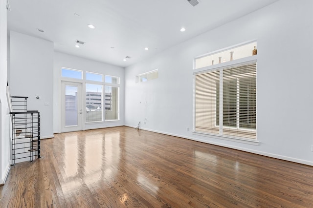 interior space featuring baseboards, visible vents, wood finished floors, and recessed lighting