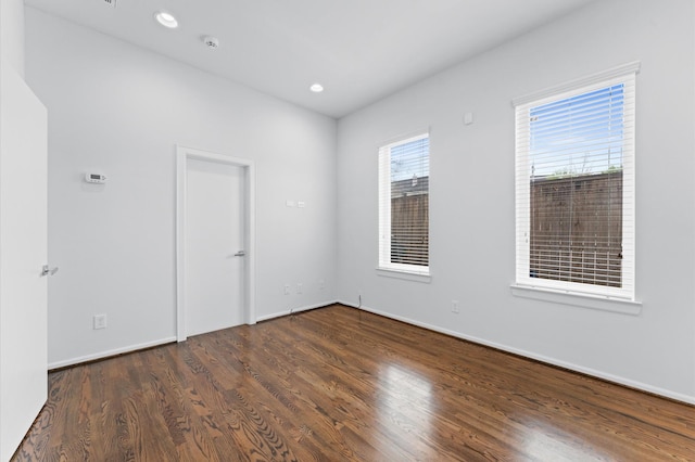 unfurnished room with recessed lighting, baseboards, and wood finished floors