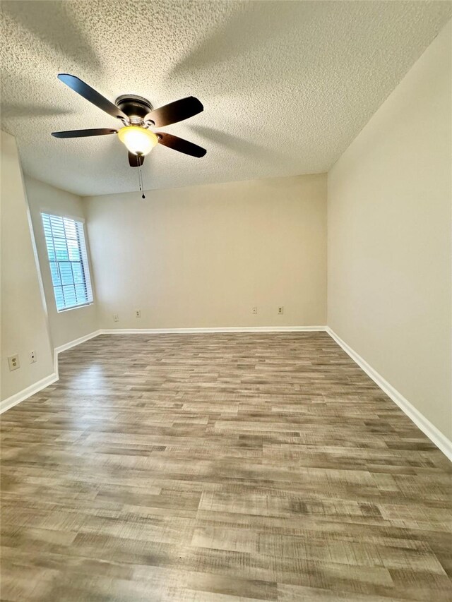 2750 Holly Hall St Unit 1301, Houston, TX 77054 - unfurnished room with ceiling fan, a textured ceiling, wood finished floors, and baseboards