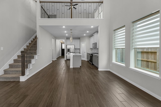 kitchen with dark wood-type flooring, a notable chandelier, and appliances with stainless steel finishes