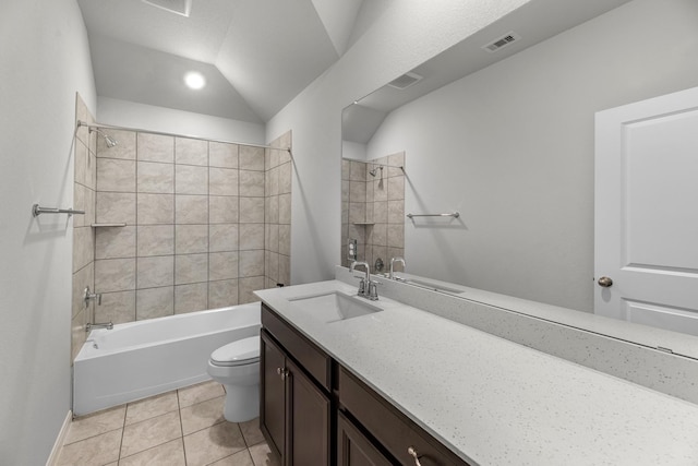 bathroom with visible vents, toilet, tile patterned floors, lofted ceiling, and bathing tub / shower combination