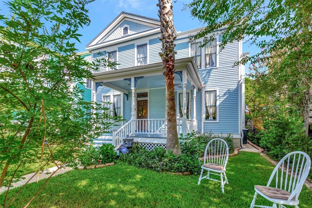 view of front of home featuring a front lawn and a porch