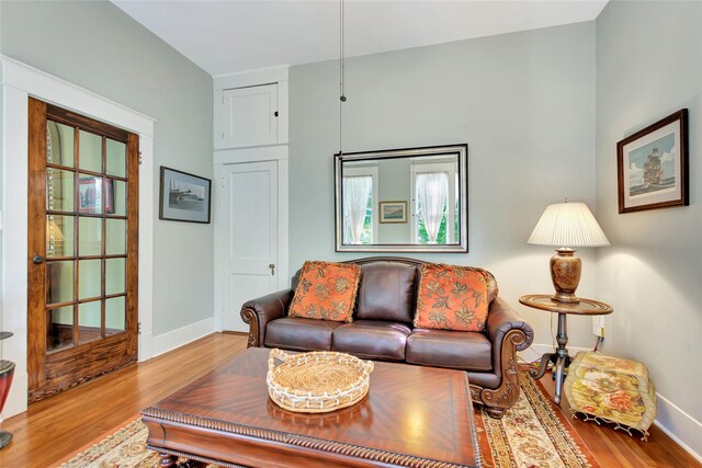 living area featuring baseboards and wood finished floors