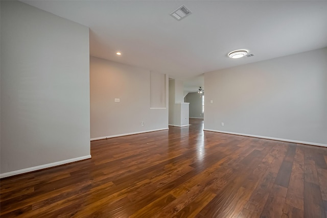 unfurnished room featuring a ceiling fan, dark wood-style floors, baseboards, visible vents, and recessed lighting