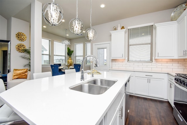 kitchen with light countertops, a sink, and tasteful backsplash