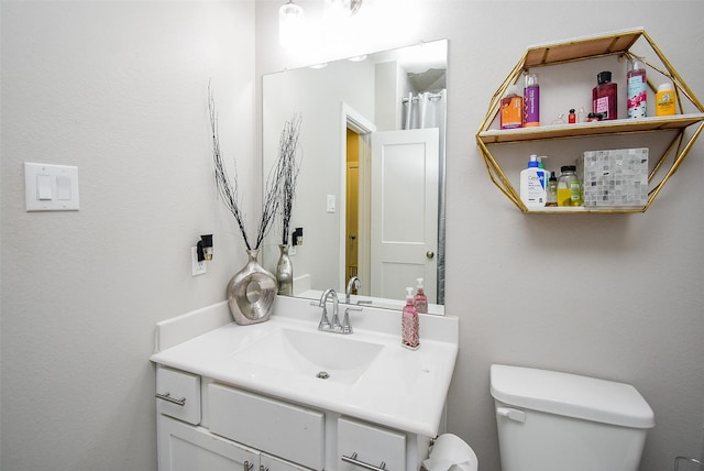 bathroom with toilet and vanity
