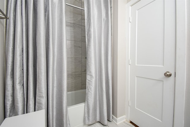 bathroom featuring shower / tub combo with curtain