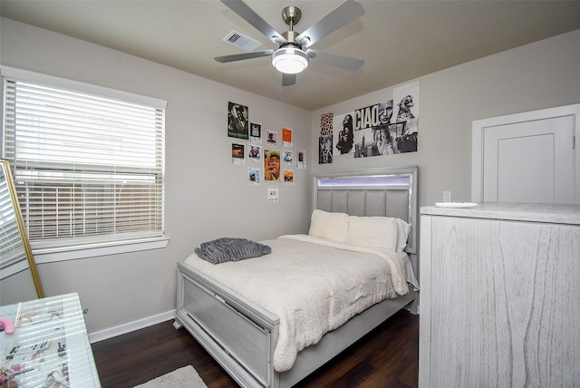 bedroom with baseboards, visible vents, a ceiling fan, and dark wood-style flooring