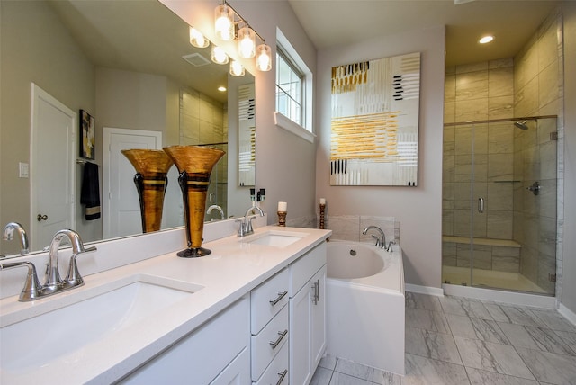 bathroom featuring a bath, marble finish floor, a sink, and a stall shower