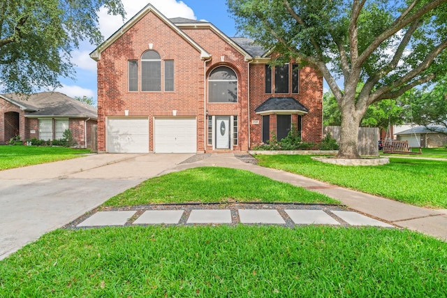 traditional-style house with an attached garage, a front yard, brick siding, and concrete driveway
