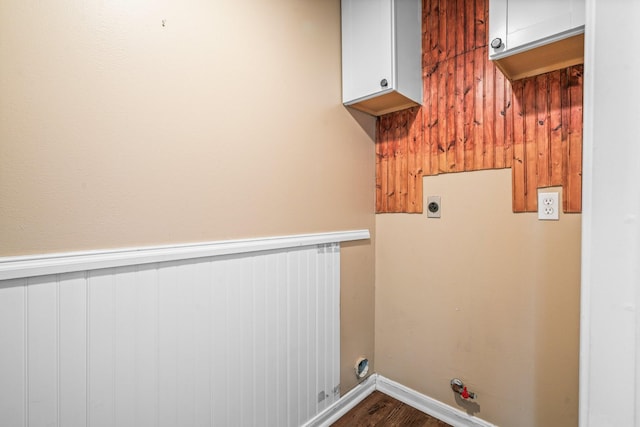 laundry room with gas dryer hookup, hookup for an electric dryer, laundry area, dark wood-style flooring, and a wainscoted wall