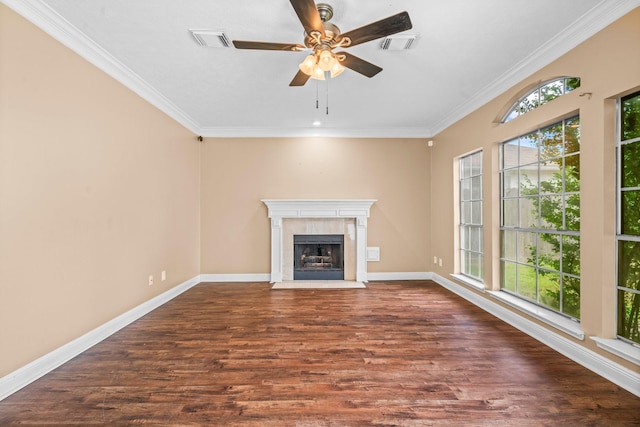 unfurnished living room with crown molding, baseboards, visible vents, and wood finished floors