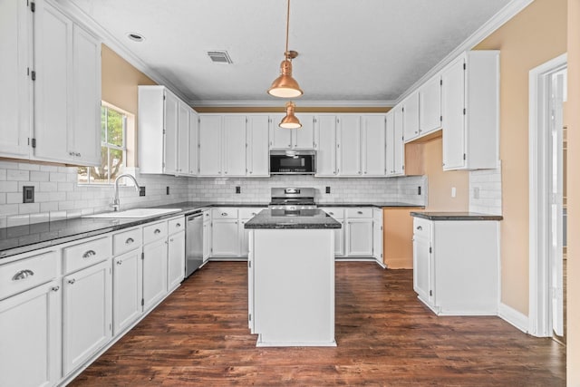 kitchen with visible vents, a sink, appliances with stainless steel finishes, and dark countertops