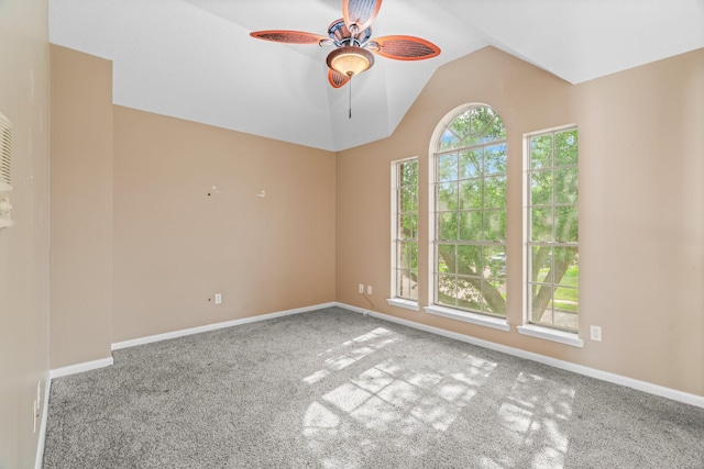unfurnished room with baseboards, a ceiling fan, carpet, and lofted ceiling