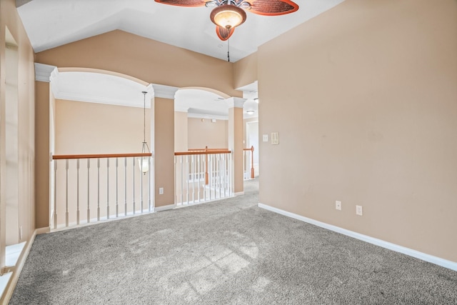 carpeted spare room with ceiling fan, baseboards, and lofted ceiling