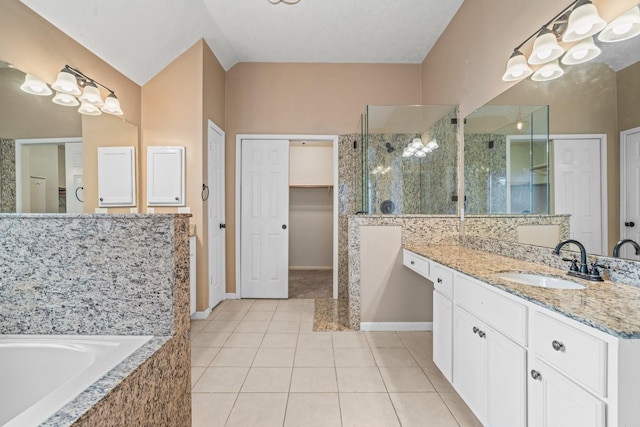 full bathroom featuring a garden tub, vanity, baseboards, tile patterned floors, and a shower stall