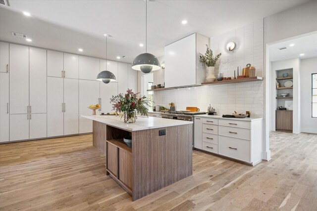 519 Milwaukee St, Houston, TX 77009 - kitchen featuring a center island, visible vents, light wood-style flooring, and open shelves
