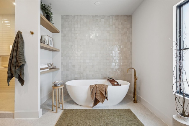 519 Milwaukee St, Houston, TX 77009 - full bathroom with a freestanding tub, baseboards, and tile walls