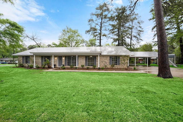 ranch-style home with metal roof and a front lawn