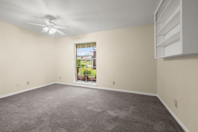 carpeted spare room with baseboards, a textured ceiling, and ceiling fan