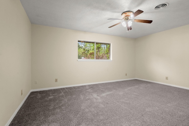 unfurnished room featuring baseboards, a textured ceiling, carpet floors, visible vents, and a ceiling fan