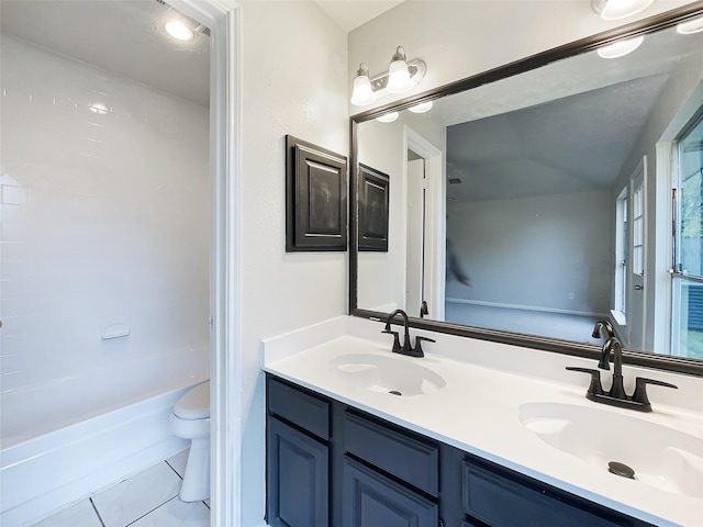 full bathroom featuring double vanity, a sink, toilet, and tile patterned flooring