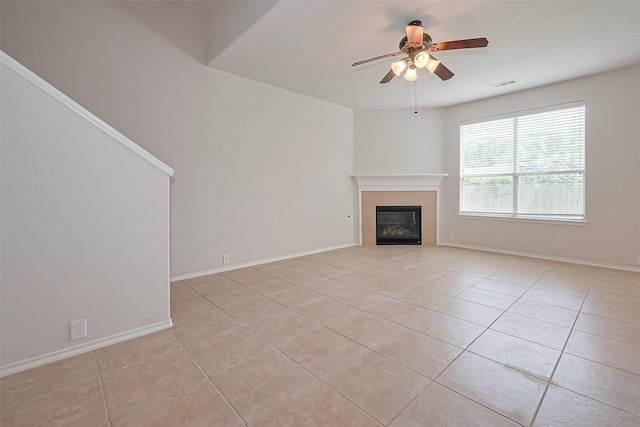13600 Breton Ridge St Unit 22D, Houston, TX 77070 - unfurnished living room with a ceiling fan, a tile fireplace, light tile patterned flooring, and baseboards