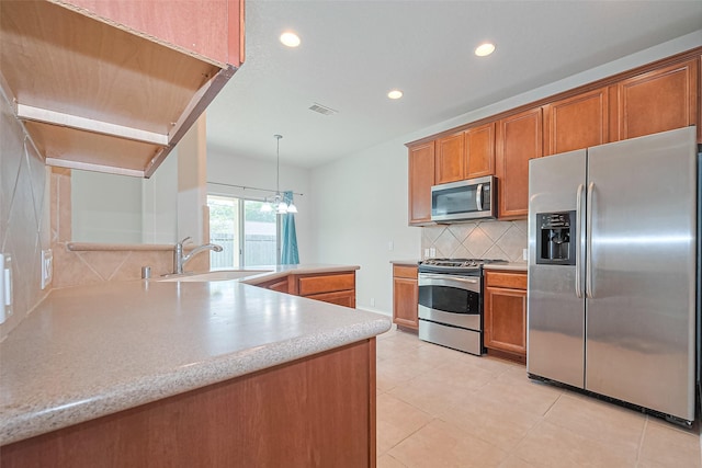 13600 Breton Ridge St Unit 22D, Houston, TX 77070 - kitchen featuring appliances with stainless steel finishes, a sink, brown cabinetry, recessed lighting, and tasteful backsplash