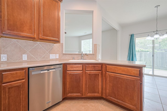13600 Breton Ridge St Unit 22D, Houston, TX 77070 - kitchen with stainless steel dishwasher, a sink, light tile patterned flooring, brown cabinetry, and light countertops