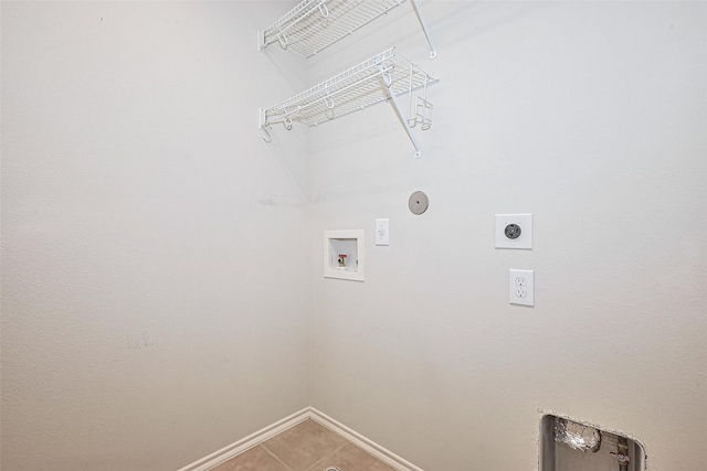 13600 Breton Ridge St Unit 22D, Houston, TX 77070 - laundry room featuring hookup for an electric dryer, washer hookup, baseboards, and light tile patterned floors