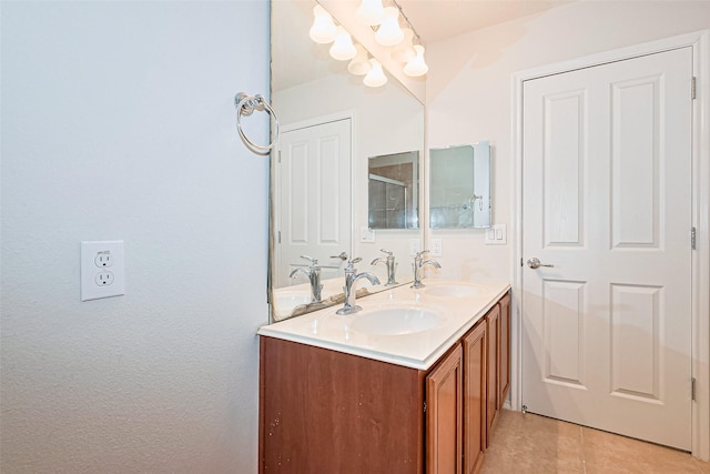 13600 Breton Ridge St Unit 22D, Houston, TX 77070 - bathroom with double vanity, tile patterned flooring, and a shower with door