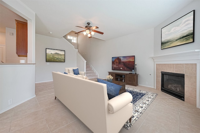 13600 Breton Ridge St Unit 22D, Houston, TX 77070 - living area featuring light tile patterned floors, ceiling fan, stairs, and a tiled fireplace