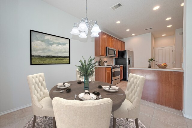 13600 Breton Ridge St Unit 22D, Houston, TX 77070 - dining space with a chandelier, recessed lighting, light tile patterned floors, and baseboards