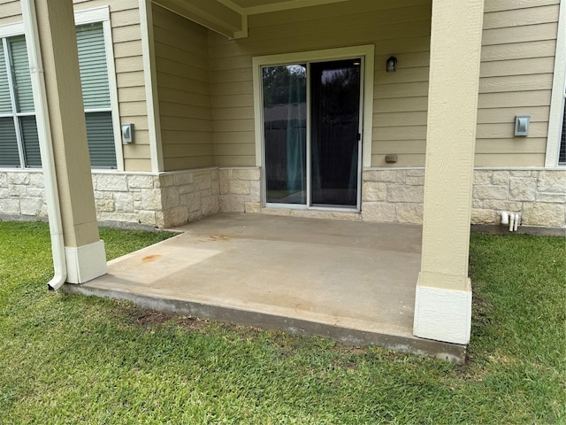 13600 Breton Ridge St Unit 22D, Houston, TX 77070 - doorway to property with stone siding and a patio