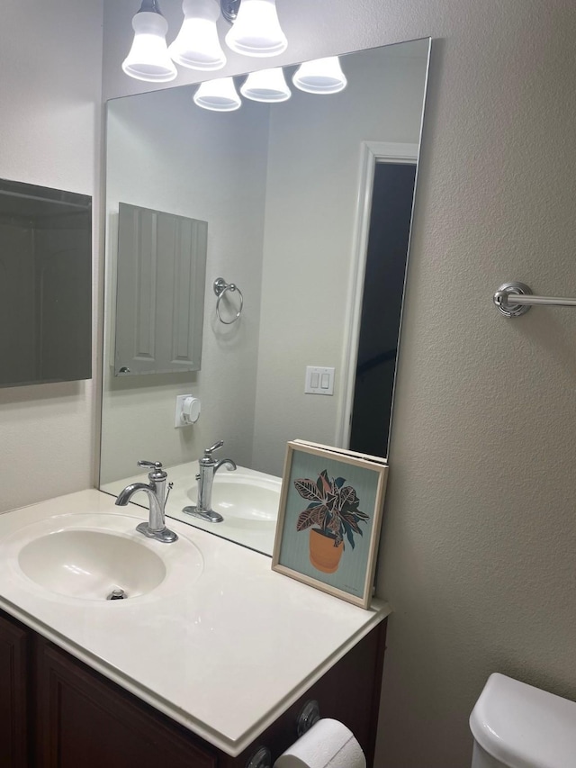 13600 Breton Ridge St Unit 22D, Houston, TX 77070 - half bathroom with toilet, vanity, and a textured wall