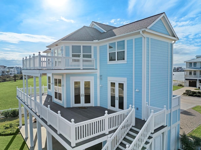 20919 W Sunset Bay Dr, Galveston, TX 77554 - rear view of property featuring french doors, a lawn, a deck, and roof with shingles