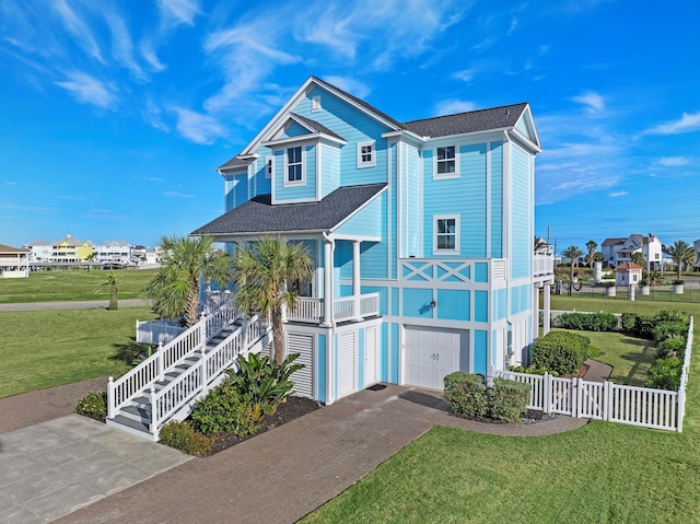 20919 W Sunset Bay Dr, Galveston, TX 77554 - raised beach house featuring an attached garage, fence, a front yard, and decorative driveway