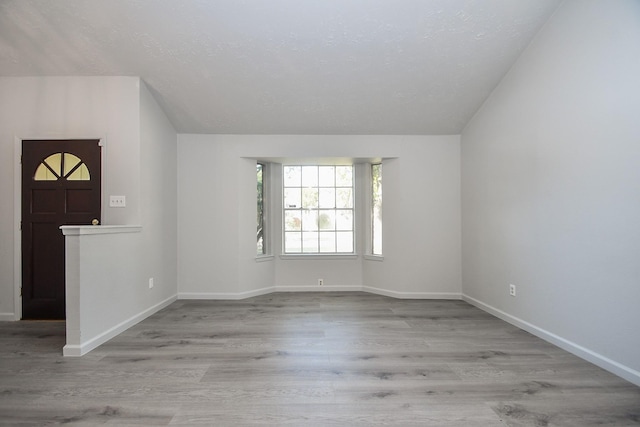 15827 Tammany Ln, Houston, TX 77082 - interior space featuring baseboards, vaulted ceiling, and wood finished floors